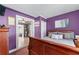 Comfortable bedroom with purple walls and bed that leads into another room at 3778 Berdon Ln, Decatur, GA 30034