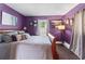 Comfortable bedroom with purple walls, carpeted floors, and decorative curtains at 3778 Berdon Ln, Decatur, GA 30034