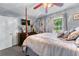 Spacious primary bedroom featuring a four poster bed, tv, dresser and sunny window view at 3778 Berdon Ln, Decatur, GA 30034