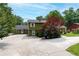 A spacious home exterior showcasing the expansive driveway and lovely yard at 3778 Berdon Ln, Decatur, GA 30034