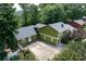 View of the home's exterior with a spacious driveway, lush landscaping, and charming details at 3778 Berdon Ln, Decatur, GA 30034