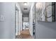 Hallway with hardwood floors, multiple doors, artwork, and view into other rooms at 3778 Berdon Ln, Decatur, GA 30034