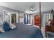 Main bedroom with a large bed, neutral paint, carpeted floors, and multiple doors at 3778 Berdon Ln, Decatur, GA 30034