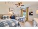 Bright bedroom featuring twin beds with blue-and-white bedding and a ceiling fan at 3812 Chattawood Dr, Duluth, GA 30096