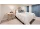 Neutral bedroom with a comfortable bed, bedside table, and soft lighting at 3812 Chattawood Dr, Duluth, GA 30096