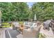 Outdoor deck furnished with comfortable seating, grill, and lush green surroundings at 3812 Chattawood Dr, Duluth, GA 30096