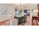 Bright dining room featuring a green dining table, chandelier, and hardwood floors and views to the Gathering room at 3812 Chattawood Dr, Duluth, GA 30096