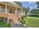 A welcoming brick home entrance featuring a covered porch with white railings and mature landscaping at 3812 Chattawood Dr, Duluth, GA 30096