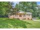 Charming brick home with a well-manicured lawn, inviting front porch and beautiful mature trees providing plenty of shade at 3812 Chattawood Dr, Duluth, GA 30096