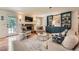Cozy living room with a stone fireplace, built-in shelves, and an access door to the backyard at 3812 Chattawood Dr, Duluth, GA 30096