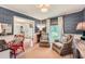 Stylish living room with textured wallpaper, comfortable seating, and abundant natural light, creating a relaxing and inviting space at 3812 Chattawood Dr, Duluth, GA 30096