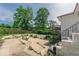 Spacious backyard, featuring a stone staircase, concrete patio and mature trees at 975 Dill Sw Ave, Atlanta, GA 30310