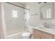 Bathroom featuring white marble shower with shower head, vanity, mirror and toilet at 975 Dill Sw Ave, Atlanta, GA 30310