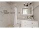 A bathroom featuring marble tile shower, white vanity with marble countertop, and chrome fixtures at 975 Dill Sw Ave, Atlanta, GA 30310