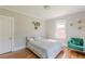 Bedroom with hardwood floors, green chair, and a light-filled window at 975 Dill Sw Ave, Atlanta, GA 30310