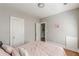 Bedroom with pink bedding, gray walls, hardwood floors, and a white door at 975 Dill Sw Ave, Atlanta, GA 30310