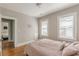 Bedroom featuring hardwood floors, neutral walls, and large windows at 975 Dill Sw Ave, Atlanta, GA 30310