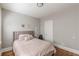 Bedroom featuring neutral decor, a bed with upholstered headboard, and hardwood floors at 975 Dill Sw Ave, Atlanta, GA 30310