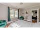 Bedroom with hardwood floors, green chair and curtains, with view into living room at 975 Dill Sw Ave, Atlanta, GA 30310