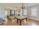 Game room with a billiard table, blending seamlessly with the adjacent living and kitchen areas, great for entertaining at 975 Dill Sw Ave, Atlanta, GA 30310
