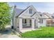 Charming one-and-a-half-story home with white painted brick, black trim and a covered porch with a swing at 975 Dill Sw Ave, Atlanta, GA 30310