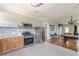 A kitchen with stainless steel appliances leads into a spacious living area with a pool table at 975 Dill Sw Ave, Atlanta, GA 30310