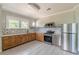 Well-lit kitchen featuring stainless steel appliances, ample cabinet space, and tiled backsplash for easy maintenance at 975 Dill Sw Ave, Atlanta, GA 30310