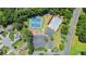 Aerial view showcases community amenities, including a pool, tennis courts, and a clubhouse surrounded by lush greenery at 1441 Hada Ln, Lawrenceville, GA 30043