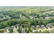 An aerial view shows this beautiful home nestled within a lush, wooded neighborhood at 1441 Hada Ln, Lawrenceville, GA 30043