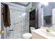Contemporary bathroom featuring a glass-enclosed shower with marble-like tile, modern vanity, and fixtures at 1441 Hada Ln, Lawrenceville, GA 30043