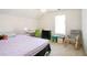 Bright bedroom featuring a cute chandelier, desk, and window for natural light at 1441 Hada Ln, Lawrenceville, GA 30043