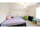 Bright bedroom featuring a cute chandelier, desk, and window for natural light at 1441 Hada Ln, Lawrenceville, GA 30043