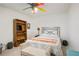 Cozy bedroom with bookshelf, sitting bench, and vibrant ceiling fan providing ample light at 1441 Hada Ln, Lawrenceville, GA 30043