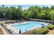 A relaxing community pool area with lounge chairs and umbrellas for residents at 1441 Hada Ln, Lawrenceville, GA 30043
