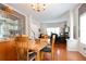 Open dining room with a wood table, display cabinet, and views to a study area at 1441 Hada Ln, Lawrenceville, GA 30043