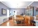 Dining room features wood floors, a chandelier, display cabinet, and natural light at 1441 Hada Ln, Lawrenceville, GA 30043