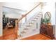 Inviting entryway showcasing beautiful hardwood floors, a staircase, and elegant decor at 1441 Hada Ln, Lawrenceville, GA 30043