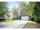 Charming brick home with a two-car garage and a lush green lawn at 1441 Hada Ln, Lawrenceville, GA 30043