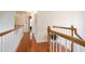 Upstairs hallway with wood floors and white railing at 1441 Hada Ln, Lawrenceville, GA 30043