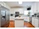 Bright kitchen features stainless steel appliances and an island with granite countertop at 1441 Hada Ln, Lawrenceville, GA 30043