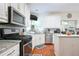 Updated kitchen features granite countertops, stainless steel appliances, and white cabinets at 1441 Hada Ln, Lawrenceville, GA 30043