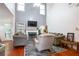 Living room with high ceilings, a fireplace, large windows, and comfortable seating at 1441 Hada Ln, Lawrenceville, GA 30043