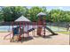 Community playground with climbing structure, slide, and a tennis court in the background at 1441 Hada Ln, Lawrenceville, GA 30043