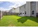 Backyard featuring a patio, green grass, and wooden privacy fence at 4135 Arch Pass, Cumming, GA 30040