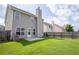 A spacious backyard with healthy lawn, a patio, and privacy fence at 4135 Arch Pass, Cumming, GA 30040
