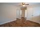 Open bedroom space featuring wood-look flooring, a ceiling fan, and multiple closets at 4135 Arch Pass, Cumming, GA 30040