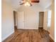 A bedroom with hardwood floors, a closet, and access to an ensuite bathroom at 4135 Arch Pass, Cumming, GA 30040