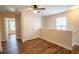 A bedroom with hardwood floors, a ceiling fan, and a window at 4135 Arch Pass, Cumming, GA 30040