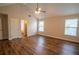 A bedroom with hardwood floors, a ceiling fan, and a large window at 4135 Arch Pass, Cumming, GA 30040