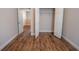 Bedroom featuring wood-look flooring, a walk-in closet, and access to additional rooms at 4135 Arch Pass, Cumming, GA 30040